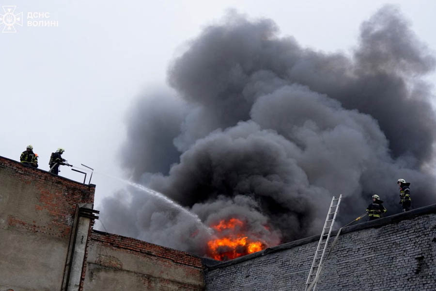 Firefighters work at the site of a Russian drone attack in Lutsk, Ukraine, on Wednesday, as thick smoke rises from a destroyed postal terminal.
