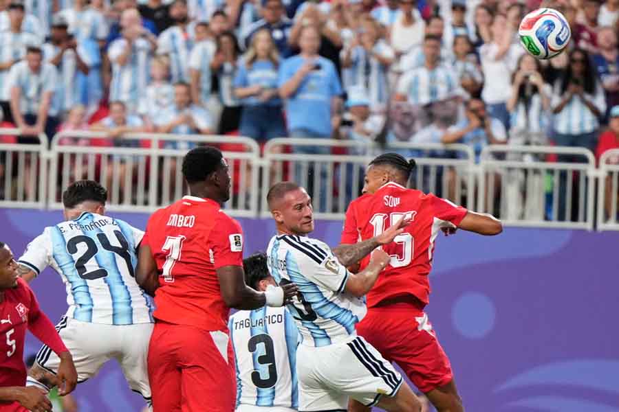 Argentina's Alexis Mac Allister heads in the opener against Switzerland