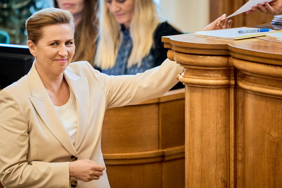 Mette Frederiksen, Denmark’s prime minister, handing a note to the parliamentary speaker while requesting permission to deliver her election statement inside the Danish parliament.