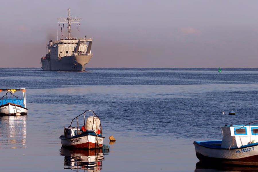 Small local boats sailing near a Mexican humanitarian aid ship anchored at Havana’s port in Cuba during the delivery of food and relief supplies.