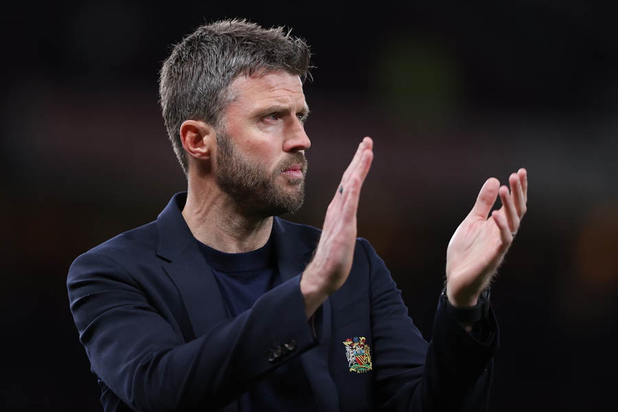 Manchester United manager Michael Carrick celebrating his team's strong league position with Champions League qualification in sight.