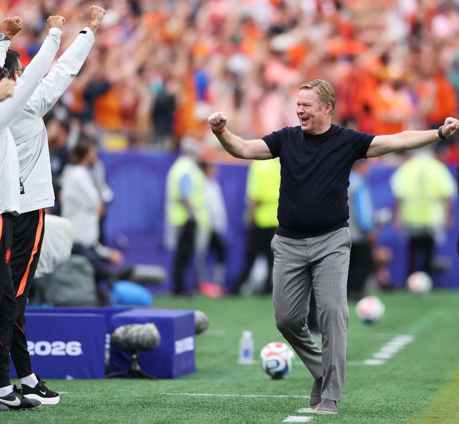 Dutch Coach and fans celebrate after the Netherlands' victory over Tunisia