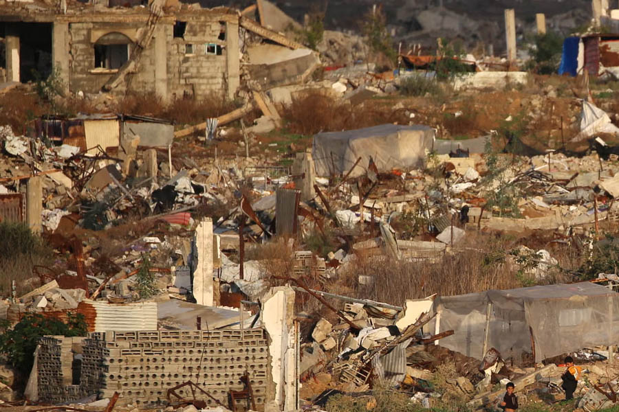 Homes and civilian buildings lie in ruins after Israeli military strikes in the Nuseirat refugee camp, central Gaza Strip, highlighting the scale of destruction on 13 December 2025.