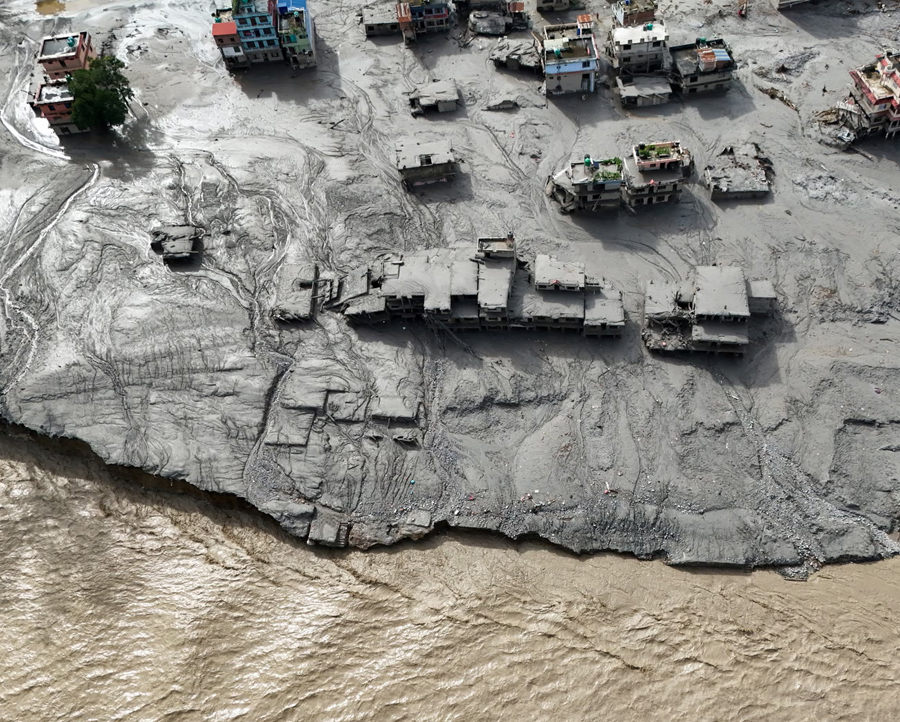 A drone view shows mud covering buildings and property following devastating floods at Trishuli in Nuwakot district, Nepal, on Thursday.