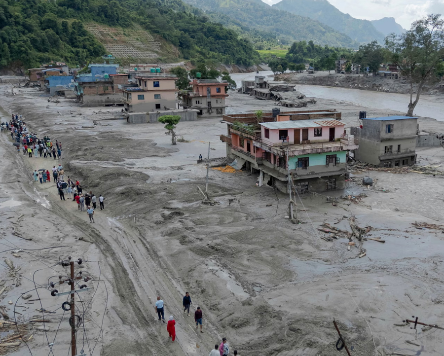 People walking in a flood-hit area in Nuwakot, Nepal, on Thursday.