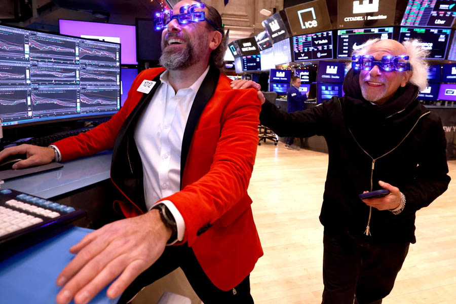 Traders on the floor of the New York Stock Exchange during New Year’s Eve trading session in New York