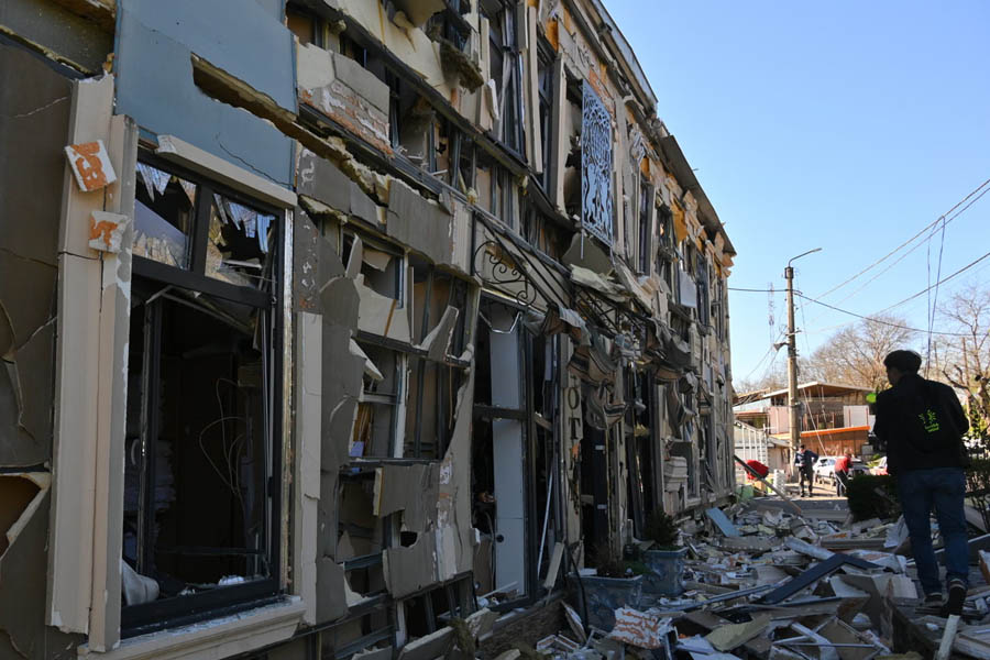 A person walks near residential houses damaged by a Russian strike in Odesa on Monday.