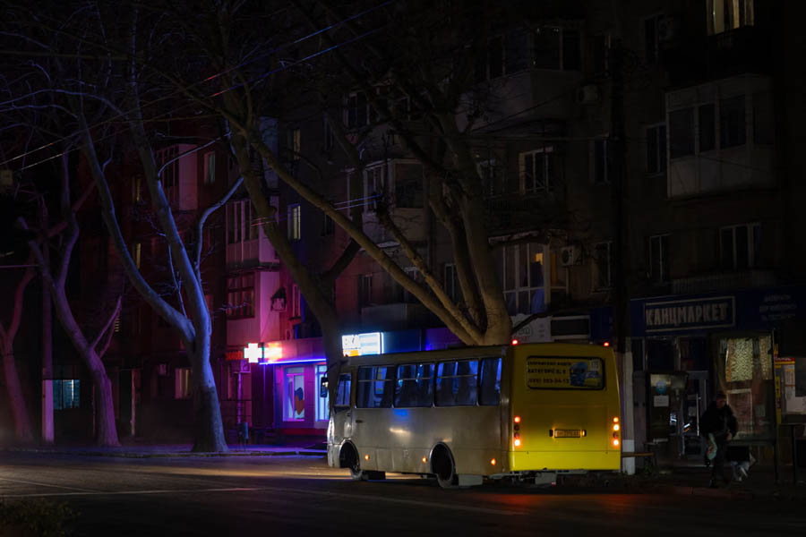 Vehicles on a dark street in Odesa, Ukraine, during a blackout caused by Russian attacks on energy facilities.