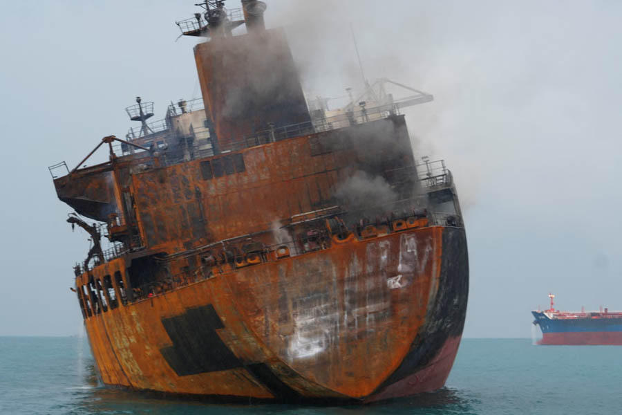 Oil tanker engulfed in flames in Iraq’s territorial waters after a suspected attack, illustrating rising maritime security risks during the Middle East war and global oil supply disruption.