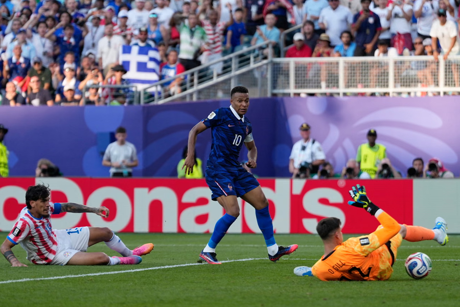 Paraguay goalkeeper Orlando Gill makes a double save from Mbappé