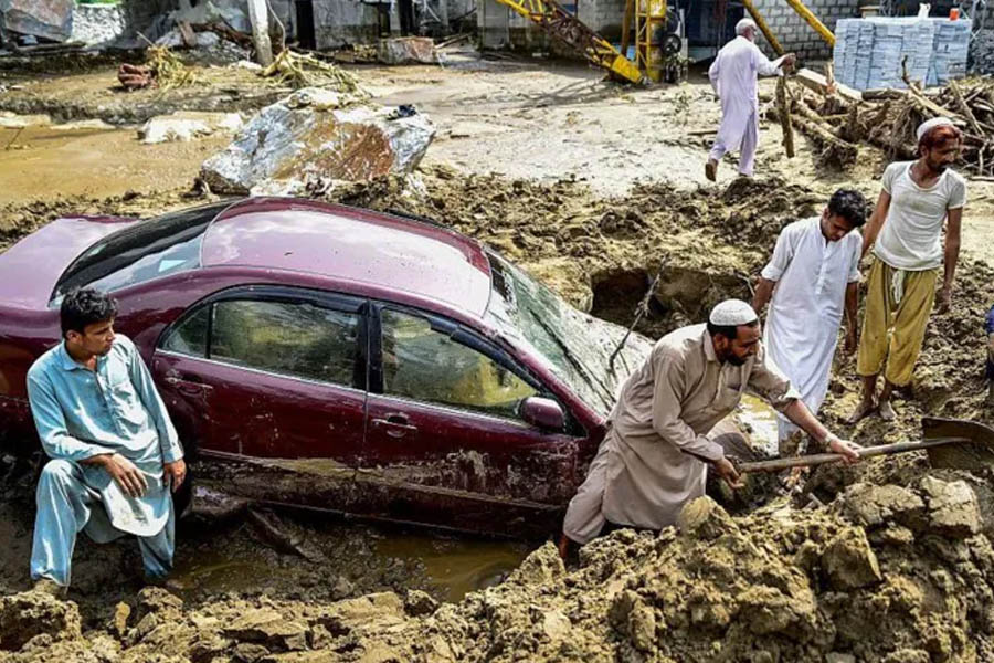 Rescue teams navigate through debris and floodwaters in Buner district, Pakistan, as monsoon rains leave hundreds missing and villages partially buried.