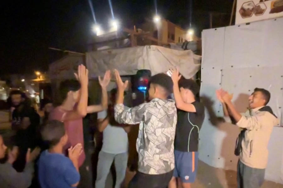 Crowds of Palestinians celebrate in Khan Younis, Gaza, following the announcement of the ceasefire deal between Israel and Hamas.