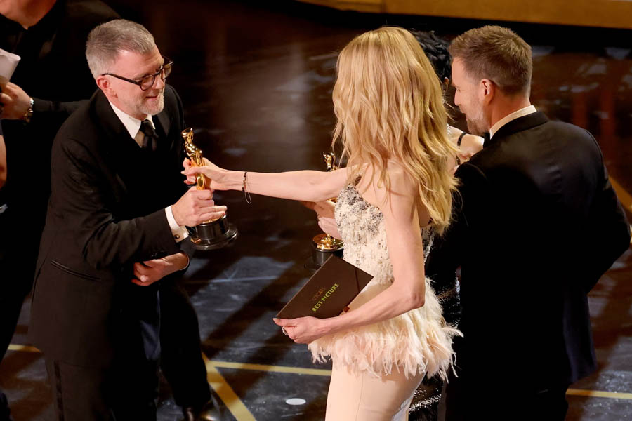 Paul Thomas Anderson receiving the Best Picture Oscar for One Battle After Another from Nicole Kidman and Ewan McGregor at the 2026 Academy Awards.