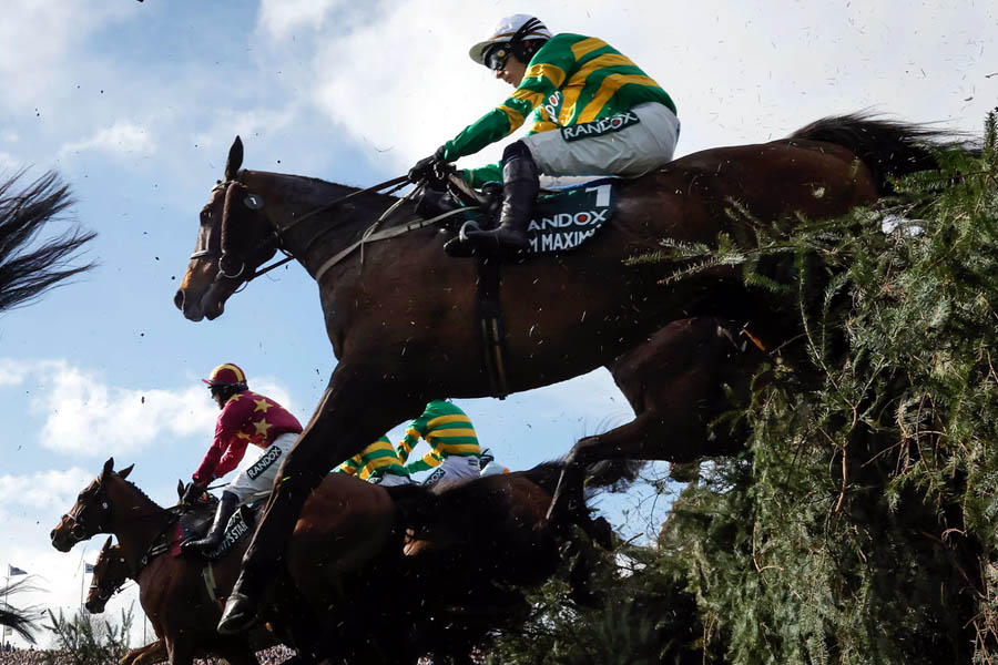 Paul Townend rides I Am Maximus over The Chair fence during their historic Grand National victory at Aintree.