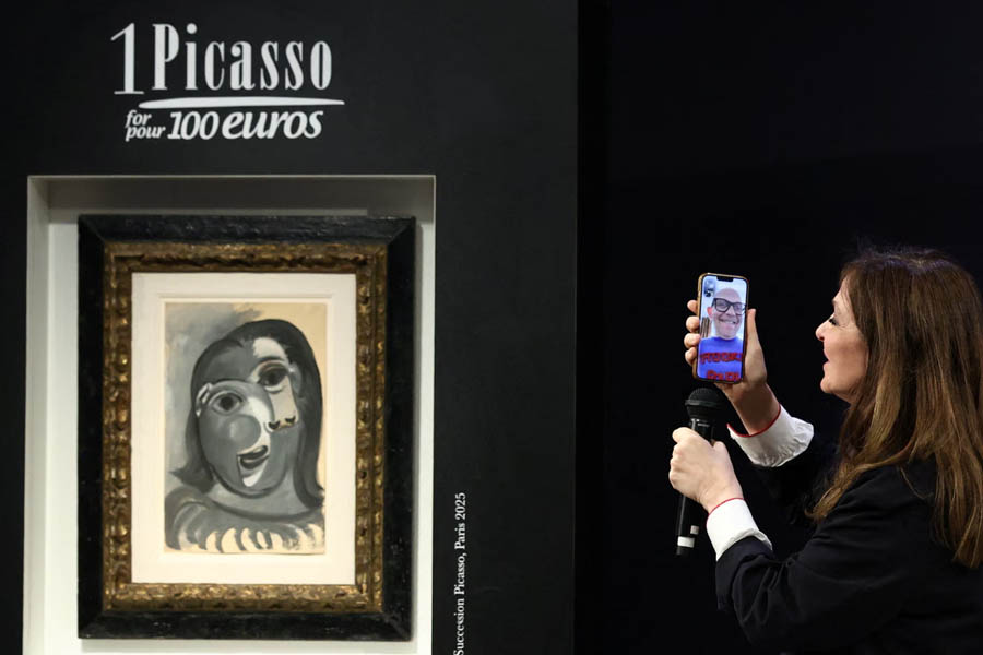 Péri Cochin, founder of the charity raffle, speaks via video call with the winner of the Pablo Picasso painting during the draw at Christie's in Paris.