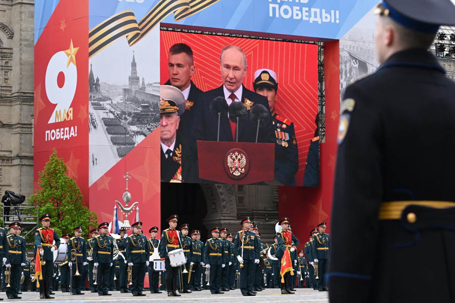 A soldier looks at a screen as Russia's president, Vladimir Putin, addresses the Victory Day military parade in Moscow.
