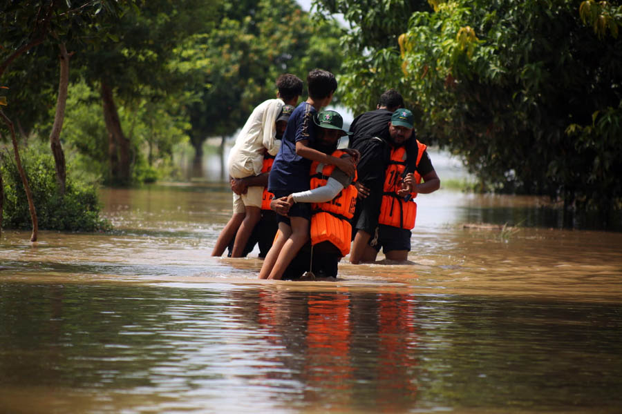Rescue workers in boats evacuating people from rising floodwaters in Multan, Punjab province, Pakistan.