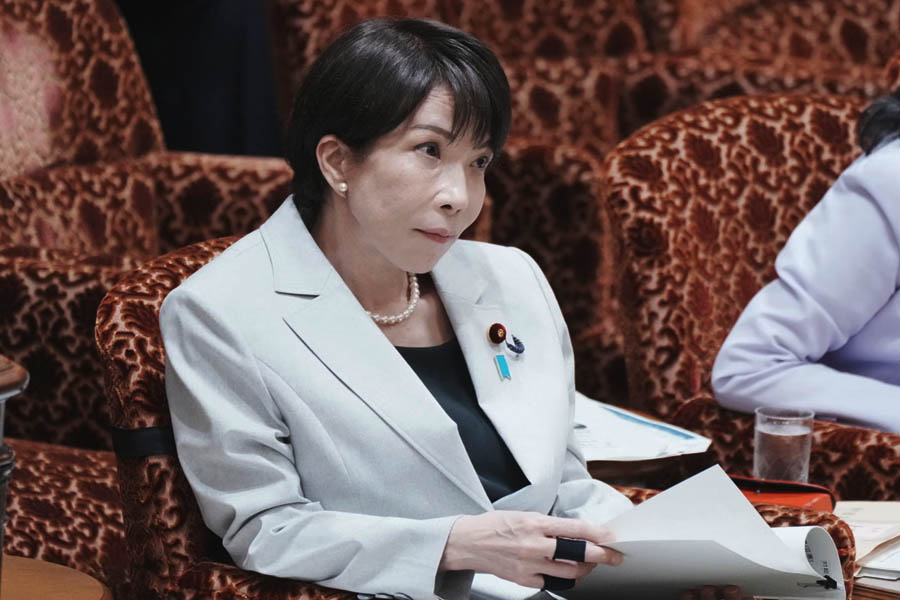 Sanae Takaichi listens to a question about the situation in the Middle East during a budget committee session.