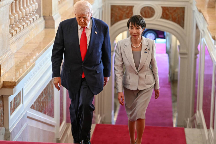 Japanese Prime Minister Sanae Takaichi walking alongside U.S. President Donald Trump at the Akasaka State Guest House in Tokyo during the U.S.–Japan summit.