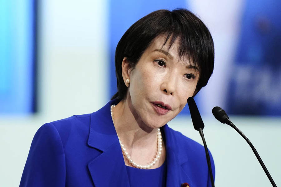 Sanae Takaichi smiling and waving after winning the Liberal Democratic Party leadership election in Tokyo.