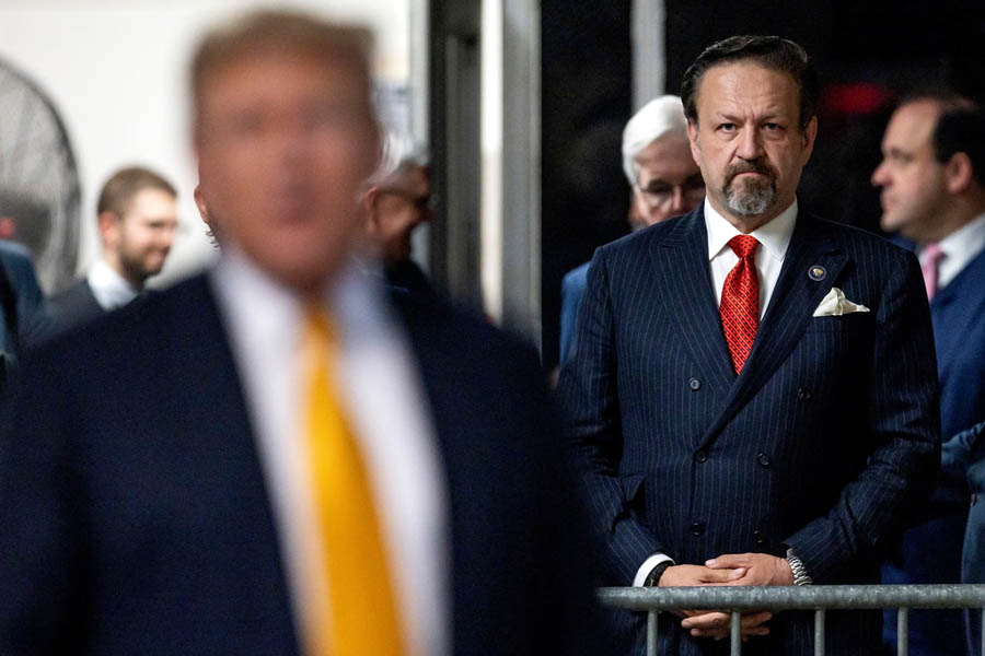 Sebastian Gorka, the White House counterterrorism tsar who spearheaded the new strategy, is pictured behind President Donald Trump.