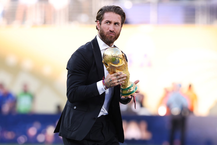 Sergio Ramos brings the World Cup trophy onto the pitch