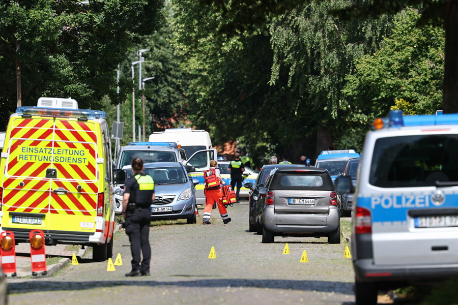 Police and rescuers work at the scene where five people were killed in a shooting in Stade, northern Germany