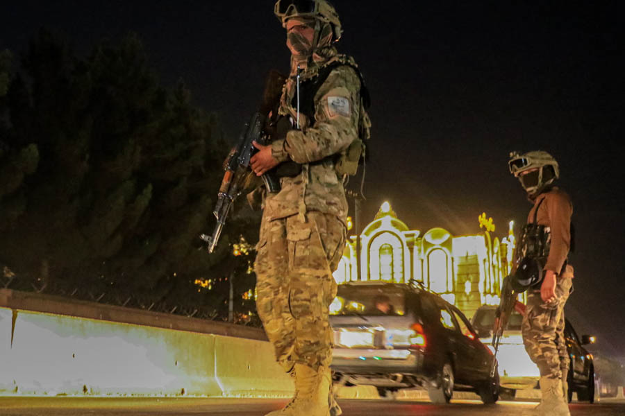 Taliban security forces checking a vehicle at a roadside checkpoint in Kabul after violent clashes along the Pakistan-Afghanistan border.