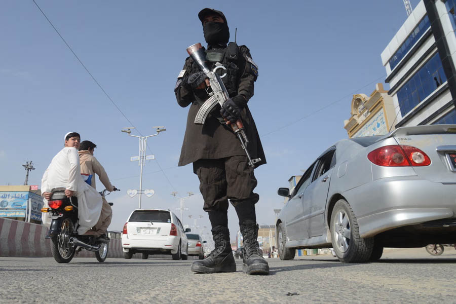 Taliban security personnel standing guard on a road in Kandahar on February 27, 2026, after overnight cross-border firing between Afghanistan and Pakistan.
