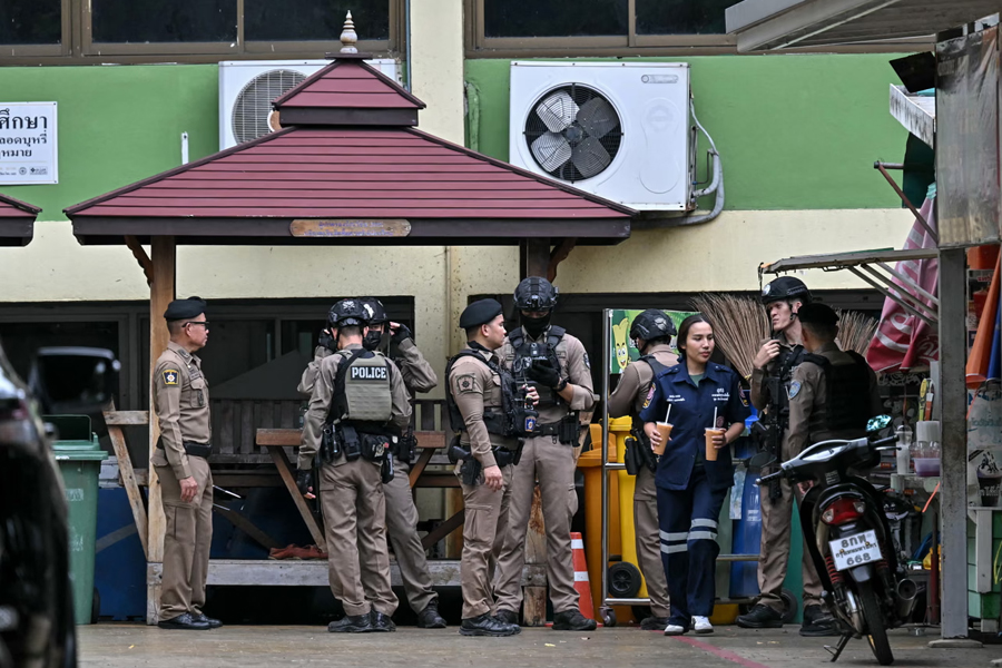 Members of the media and emergency personnel outside the school in the Nonthaburi province