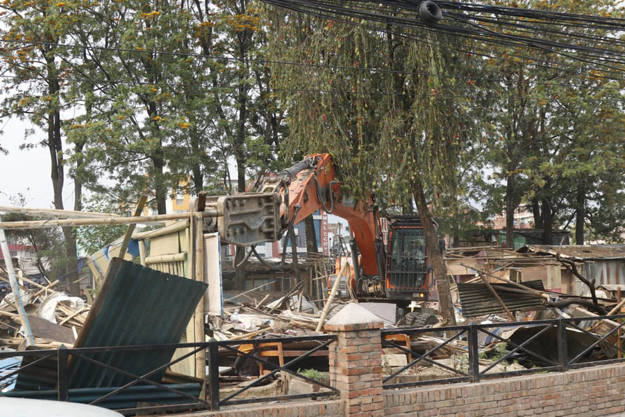 Bulldozers clear the Thapathali squatter settlement in Kathmandu during the government's eviction campaign to remove encroached public land.