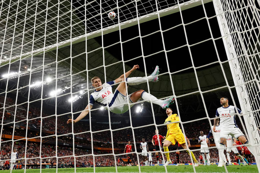 Tottenham’s Micky van de Ven acrobatically clears a Rasmus Højlund header off the line in the second half.