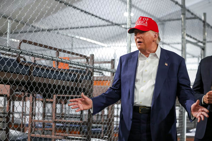 Donald Trump and Ron DeSantis visit controversial 'Alligator Alcatraz' migrant detention camp in Florida Everglades, surrounded by tents, swampland, and heavy security.
