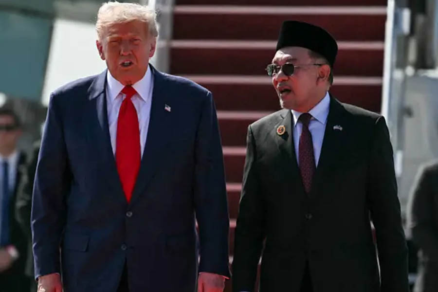 Donald Trump greeted by Malaysian Prime Minister Anwar Ibrahim as he steps off Air Force One at Kuala Lumpur International Airport during his official visit to Malaysia.