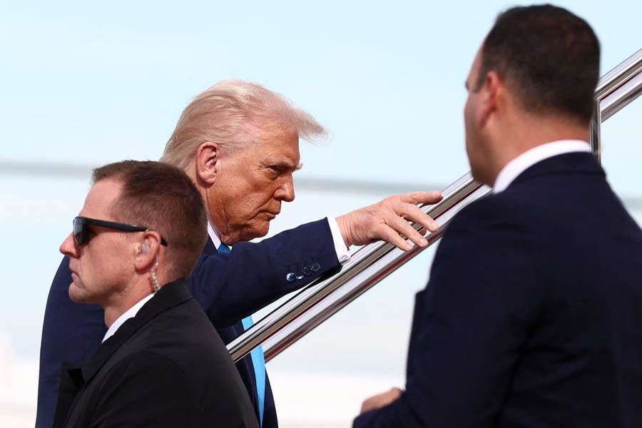 Donald Trump boarding Air Force One at Haneda Airport in Japan en route to South Korea for talks with President Lee Jae Myung.