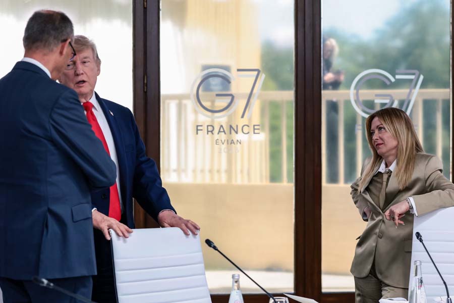 Donald Trump, Friedrich Merz, and Giorgia Meloni at a working lunch with leaders of G7. Meloni has hit back at Trump's claims that she "begged" him for a photo, calling the remarks "completely made up."