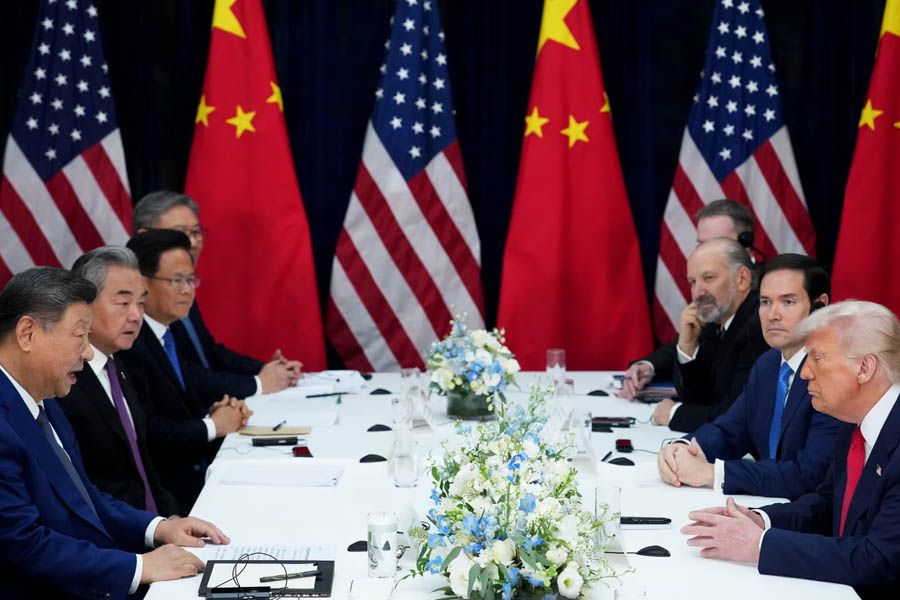 Chinese President Xi Jinping and US President Donald Trump sit at opposite ends of the negotiating table with their delegations during trade discussions in Busan.