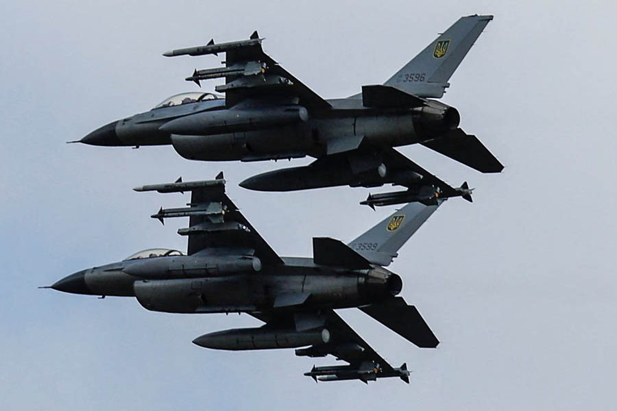 Ukrainian F-16 fighter jets flying in formation after US approval of extended-range cruise missiles for Ukraine.