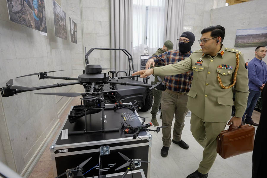 A foreign military official looks at the heavy drone-bomber dubbed "Vampire" at an exhibition of Ukrainian-made weapons in Ukraine on 13 April.