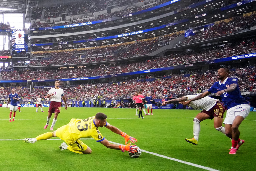 Spain's keeper Unai Simon claims the ball ahead of France's Bradley Barcola