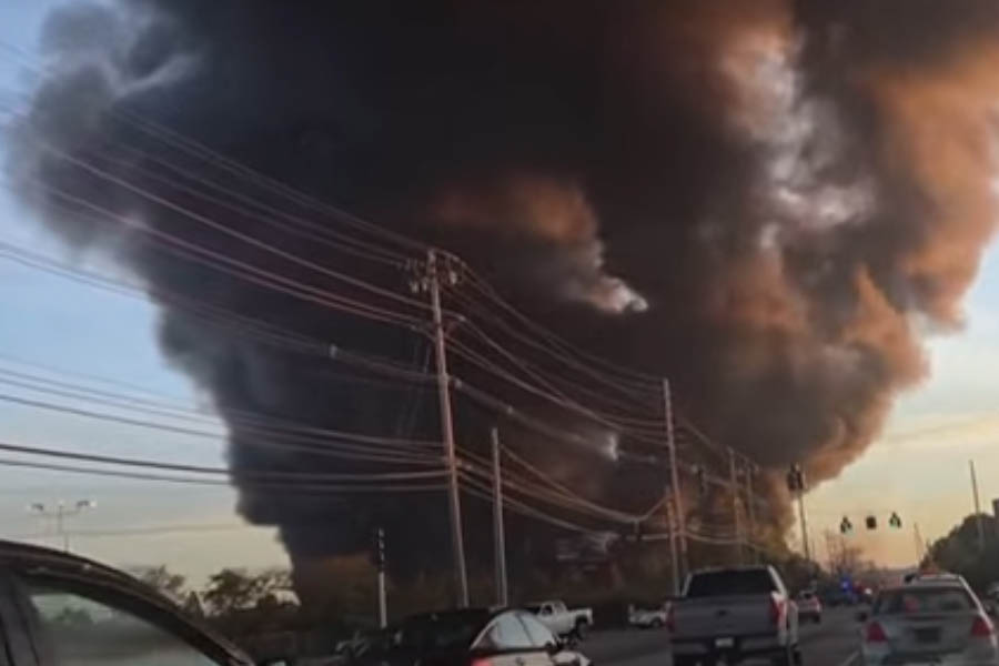 Burning wreckage of a UPS cargo plane after crashing near Louisville International Airport in Kentucky, with smoke and fire rising from the impact site.