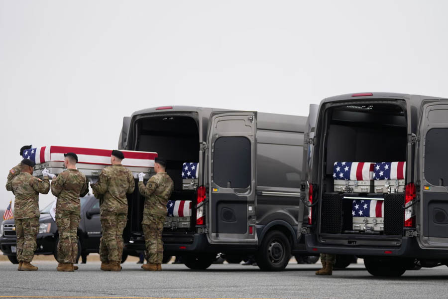 U.S. Army carry team transporting the sixth flag-draped transfer case at Dover Air Force Base during a dignified ceremony for troops killed in the Iran war.