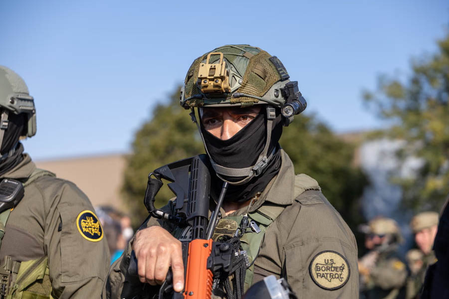 US border patrol agent standing watch in suburban Chicago during immigration enforcement operations.