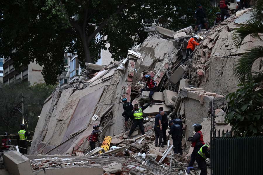 Rescuers search for victims in a collapsed building in Caracas after two powerful earthquakes struck Venezuela on Wednesday evening, killing at least 32 people and injuring 700.