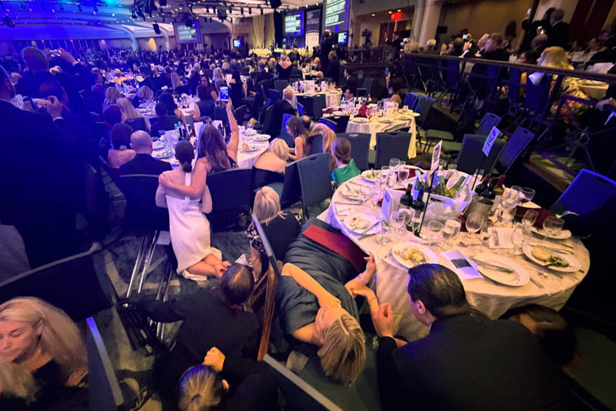 Guests take cover inside the White House Correspondents' Association dinner after President Donald Trump was rushed out by Secret Service agents following a loud unidentified noise in Washington, D.C., on April 25, 2026.