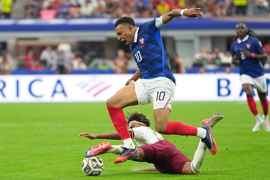 Spain's Lamine Yamal brings down France's Kylian Mbappe