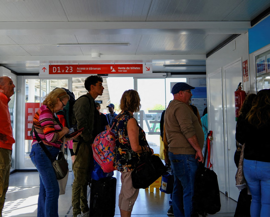 A young migrant (centre) queues in Almeria to buy a bus ticket to Valladolid, to obtain a vulnerability certificate to regularise migration status.