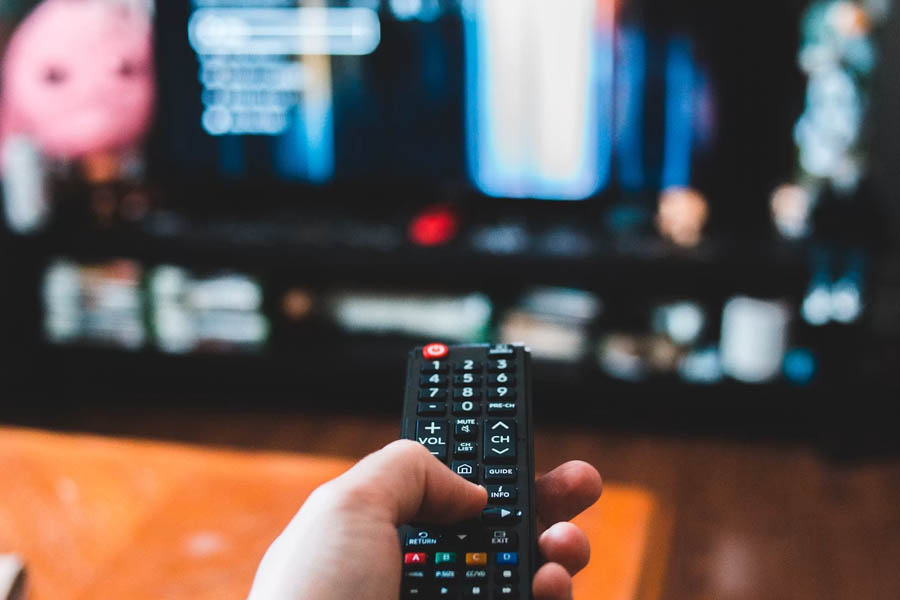 A living room with a large TV displaying YouTube content, illustrating the major shift from mobile devices to television screens for YouTube viewing between 2024 and 2025.